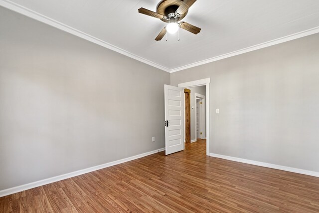 174 Main St, Toomsboro, GA 31090 - empty room featuring baseboards, crown molding, wood finished floors, and ceiling fan