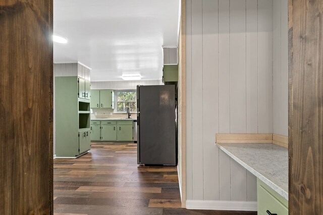 174 Main St, Toomsboro, GA 31090 - kitchen with green cabinets, freestanding refrigerator, dark wood-style floors, light countertops, and a sink
