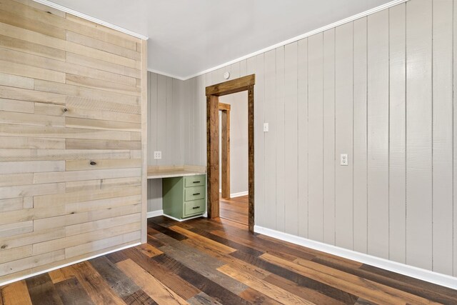 174 Main St, Toomsboro, GA 31090 - spare room with dark wood-type flooring, crown molding, baseboards, an office area, and wood walls