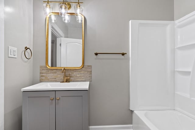 174 Main St, Toomsboro, GA 31090 - bathroom featuring decorative backsplash, vanity, and bathtub / shower combination