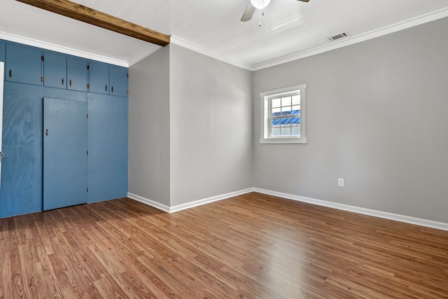 174 Main St, Toomsboro, GA 31090 - unfurnished bedroom with wood finished floors, crown molding, baseboards, a ceiling fan, and a closet
