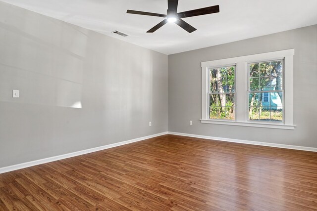 174 Main St, Toomsboro, GA 31090 - empty room featuring a ceiling fan, wood finished floors, and baseboards