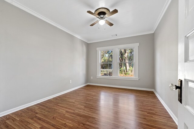 174 Main St, Toomsboro, GA 31090 - spare room with ceiling fan, crown molding, dark wood finished floors, and baseboards