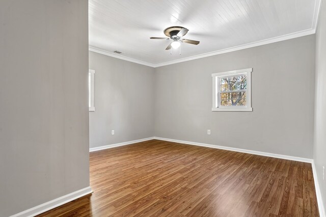 174 Main St, Toomsboro, GA 31090 - empty room featuring a ceiling fan, wood finished floors, baseboards, and ornamental molding
