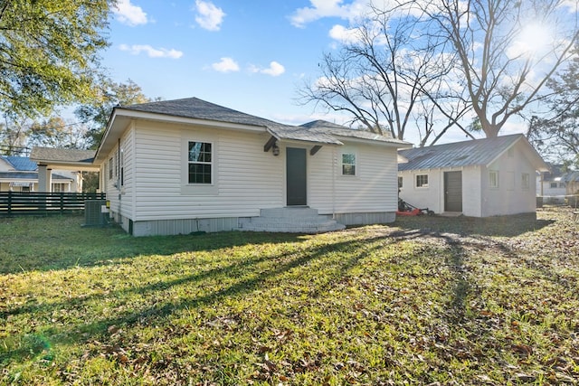 174 Main St, Toomsboro, GA 31090 - back of house featuring central AC unit and an outdoor structure