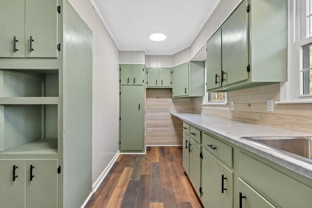 174 Main St, Toomsboro, GA 31090 - kitchen with green cabinets, light countertops, dark wood-style floors, backsplash, and ornamental molding