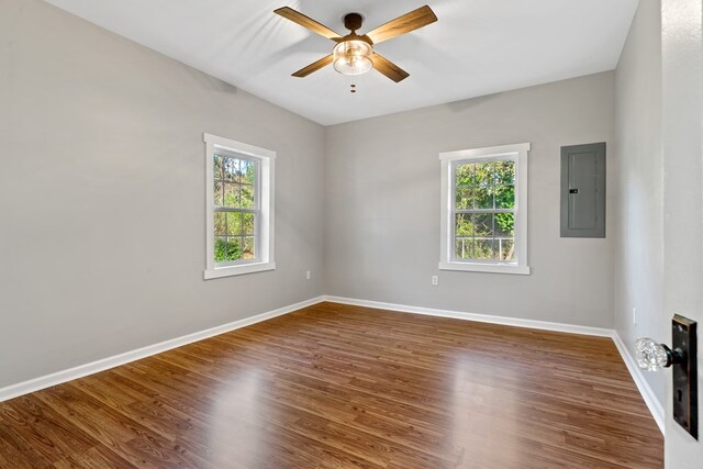 174 Main St, Toomsboro, GA 31090 - unfurnished room featuring electric panel, plenty of natural light, a ceiling fan, and baseboards