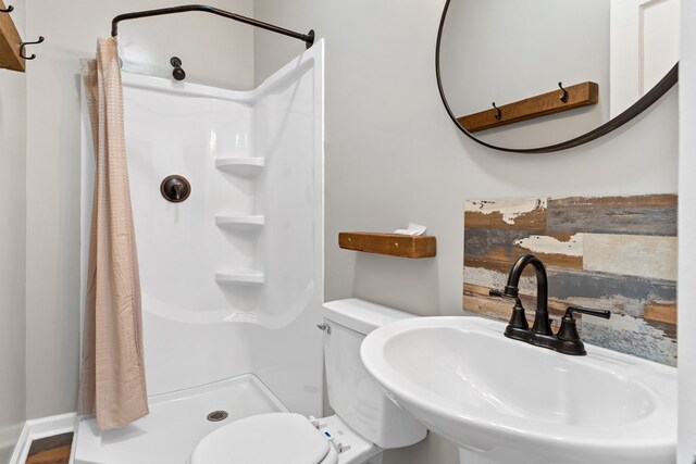 174 Main St, Toomsboro, GA 31090 - bathroom with a sink, a stall shower, and toilet