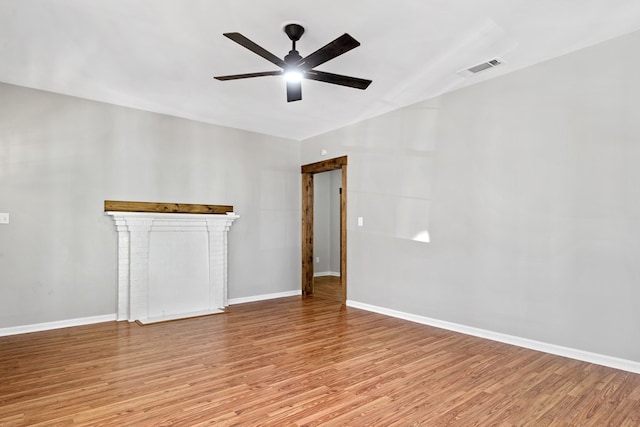 174 Main St, Toomsboro, GA 31090 - spare room featuring light wood-type flooring, a ceiling fan, and baseboards