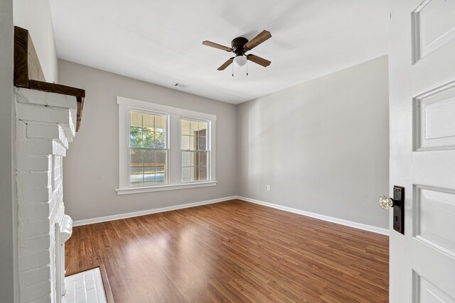 174 Main St, Toomsboro, GA 31090 - unfurnished living room featuring a ceiling fan, wood finished floors, and baseboards
