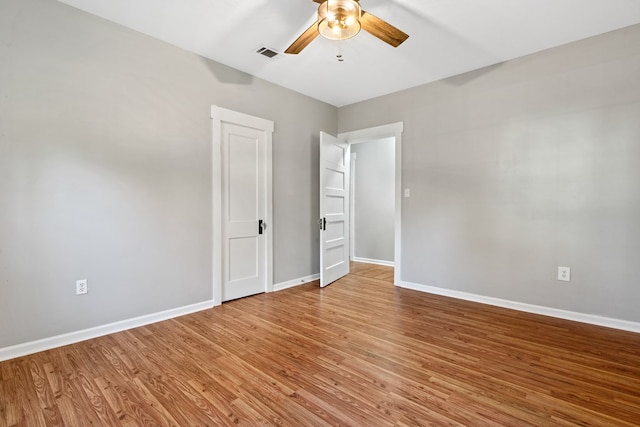 174 Main St, Toomsboro, GA 31090 - spare room featuring ceiling fan, light wood-style floors, and baseboards