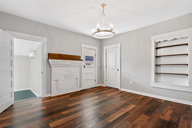 174 Main St, Toomsboro, GA 31090 - unfurnished dining area with a chandelier, wood finished floors, baseboards, and an AC wall unit