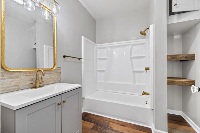 174 Main St, Toomsboro, GA 31090 - bathroom featuring tasteful backsplash, wood finished floors, vanity, and shower / bathtub combination