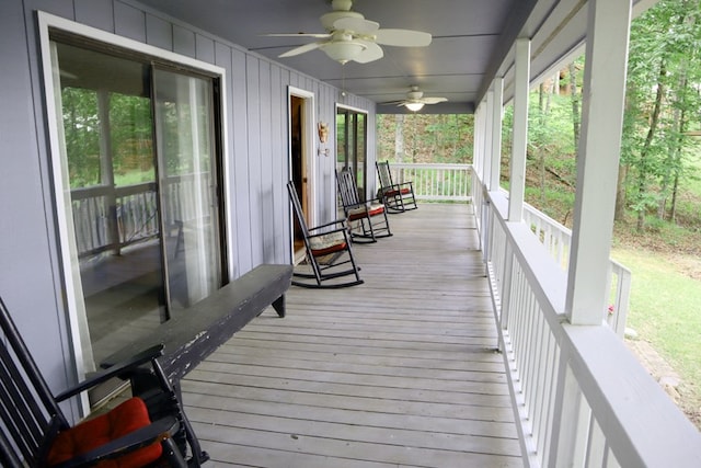 wooden terrace with covered porch and ceiling fan