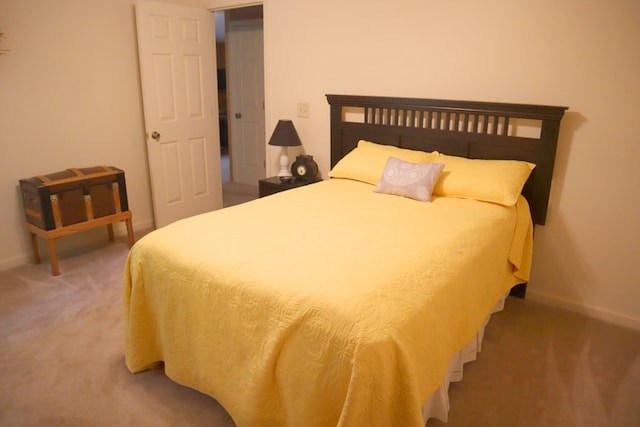 carpeted bedroom featuring baseboards
