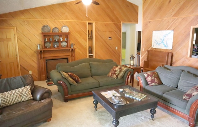 carpeted living area with a ceiling fan, wood walls, and vaulted ceiling