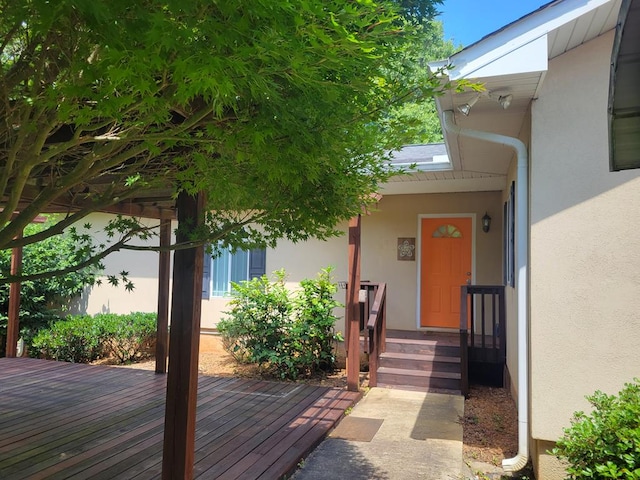 104 Wesley Ct, Eatonton, GA 31024 - doorway to property featuring stucco siding and a wooden deck