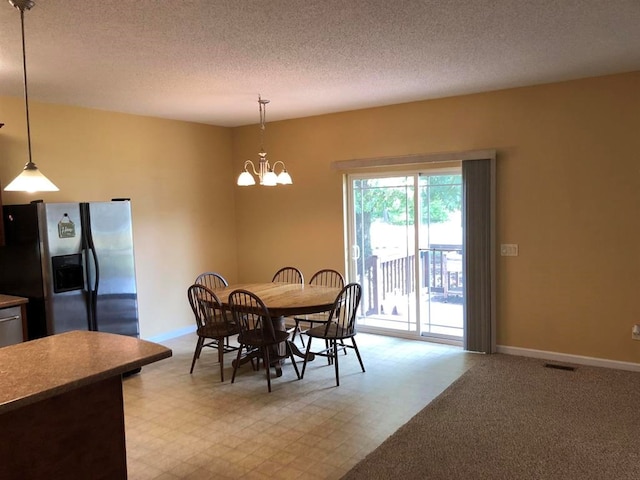 104 Wesley Ct, Eatonton, GA 31024 - dining space with a chandelier and a textured ceiling