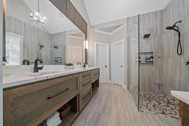 full bath featuring double vanity, a sink, vaulted ceiling, and a walk in shower
