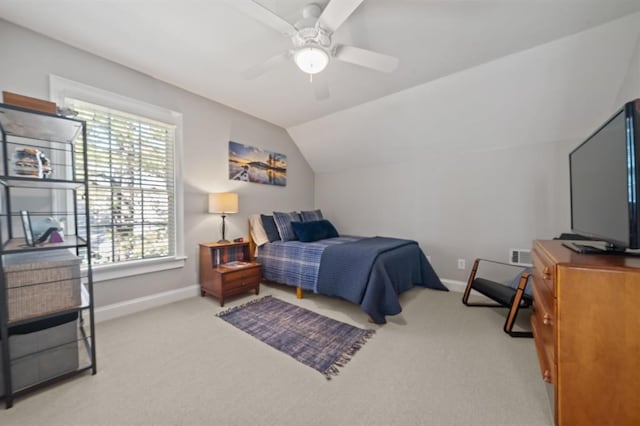 bedroom with light colored carpet, a ceiling fan, baseboards, and vaulted ceiling