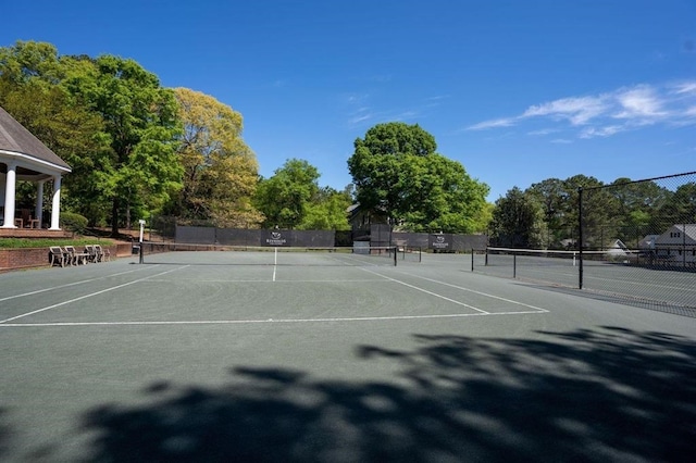 view of sport court featuring fence