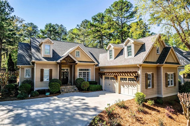 view of front of house with driveway, a shingled roof, a garage, and board and batten siding