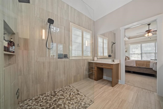 full bathroom with ceiling fan, lofted ceiling, a walk in shower, and ensuite bath