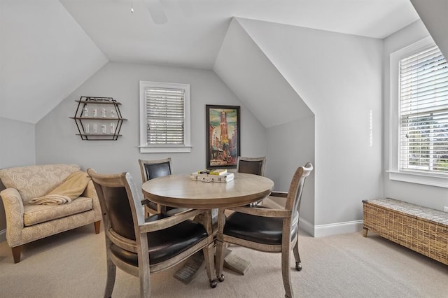 living room with baseboards, carpet flooring, ceiling fan, and vaulted ceiling