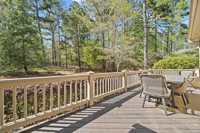 wooden terrace featuring outdoor dining area