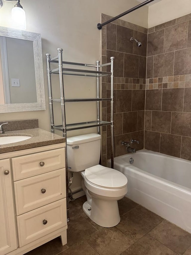 full bathroom with vanity, tile patterned flooring, toilet, and tiled shower / bath