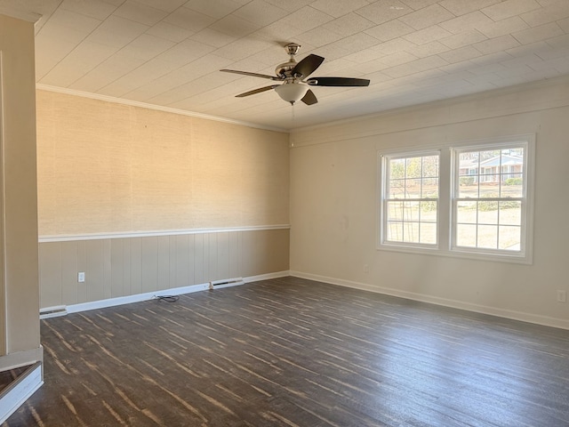 empty room featuring dark hardwood / wood-style flooring, ornamental molding, and ceiling fan