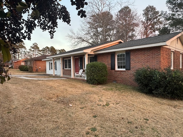 ranch-style house with a patio area and a front lawn