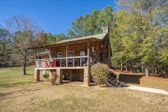 rear view of property with a yard