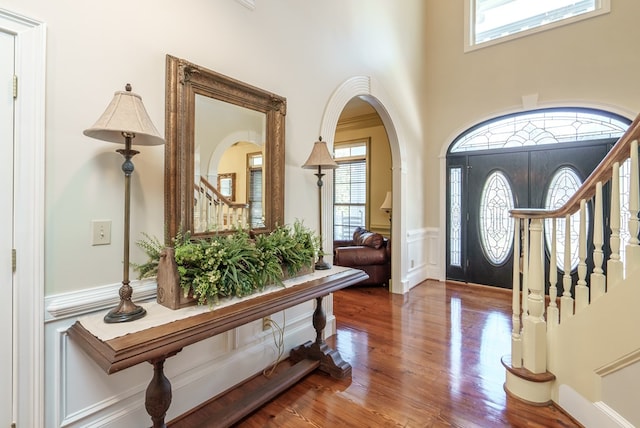 foyer featuring wood-type flooring and ornamental molding