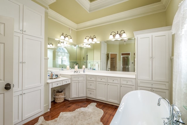 bathroom with a tub, crown molding, vanity, and wood-type flooring