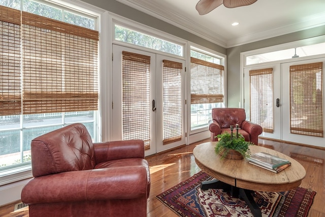 sunroom with ceiling fan, a healthy amount of sunlight, and french doors