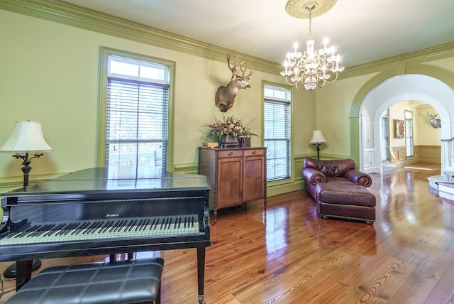 miscellaneous room featuring hardwood / wood-style floors, a healthy amount of sunlight, and an inviting chandelier