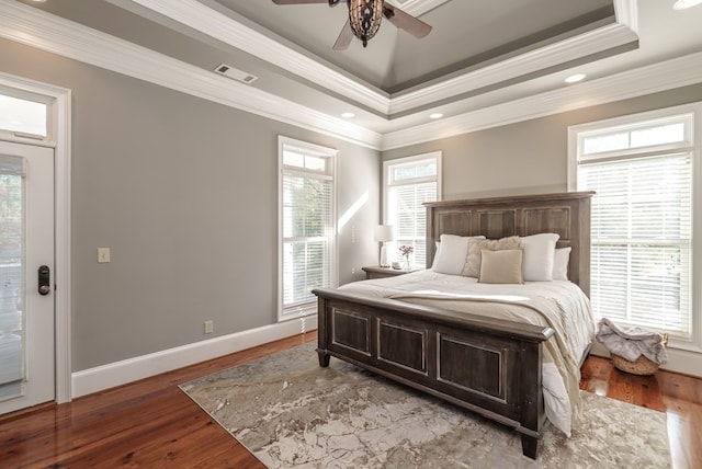 bedroom with hardwood / wood-style flooring, ceiling fan, and crown molding