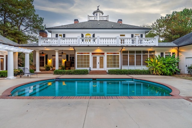 rear view of house with a patio area, ceiling fan, and french doors