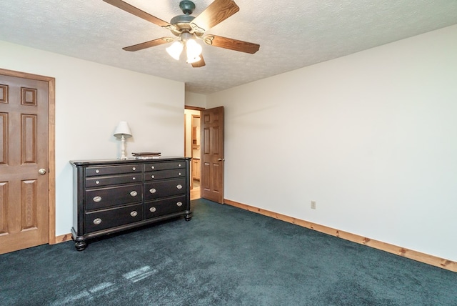 unfurnished bedroom featuring dark colored carpet, ceiling fan, and a textured ceiling