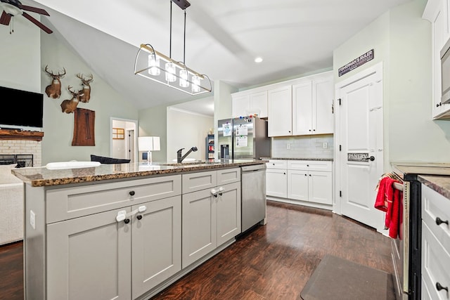 97 Heather Ln, Mansfield, GA 30055 - kitchen featuring dark wood finished floors, open floor plan, appliances with stainless steel finishes, and decorative backsplash