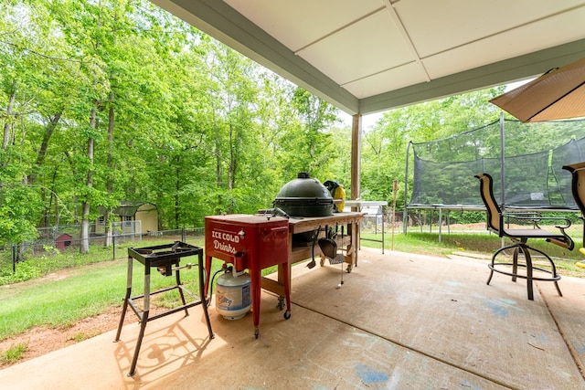 97 Heather Ln, Mansfield, GA 30055 - view of patio with a storage unit, fence, a trampoline, and an outbuilding