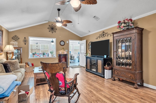 living room with crown molding, light hardwood / wood-style flooring, and lofted ceiling