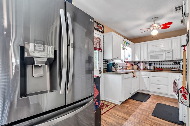 kitchen featuring backsplash, white appliances, ceiling fan, white cabinets, and light hardwood / wood-style floors