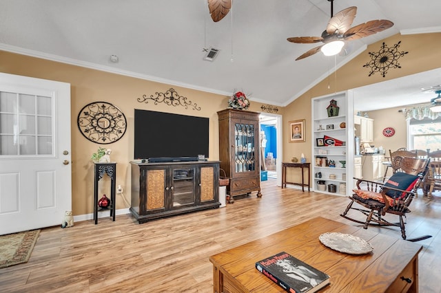 living room featuring crown molding, ceiling fan, and lofted ceiling