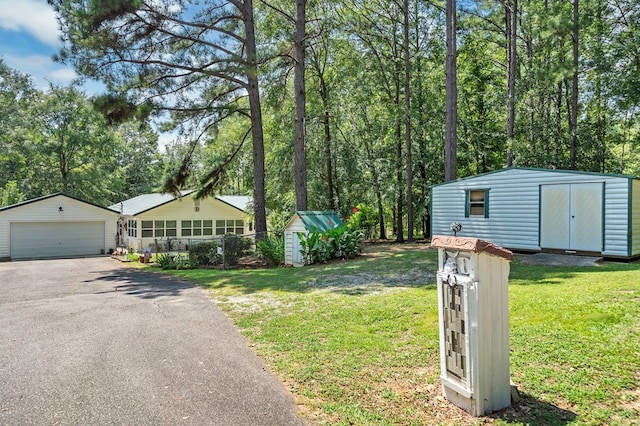 view of yard featuring a garage and a storage unit