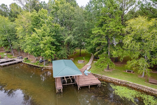 dock area with a yard and a water view