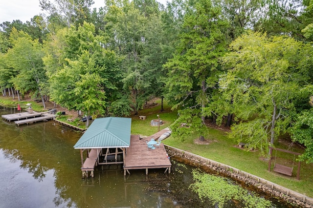 dock area featuring a lawn and a water view