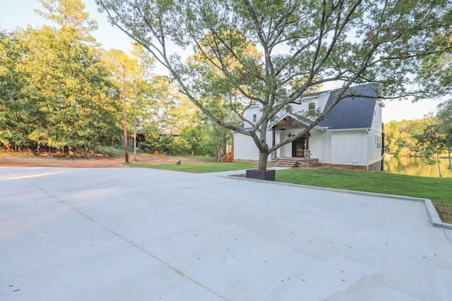 exterior space with driveway and a front yard