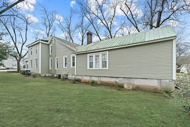 view of home's exterior featuring a yard and central AC